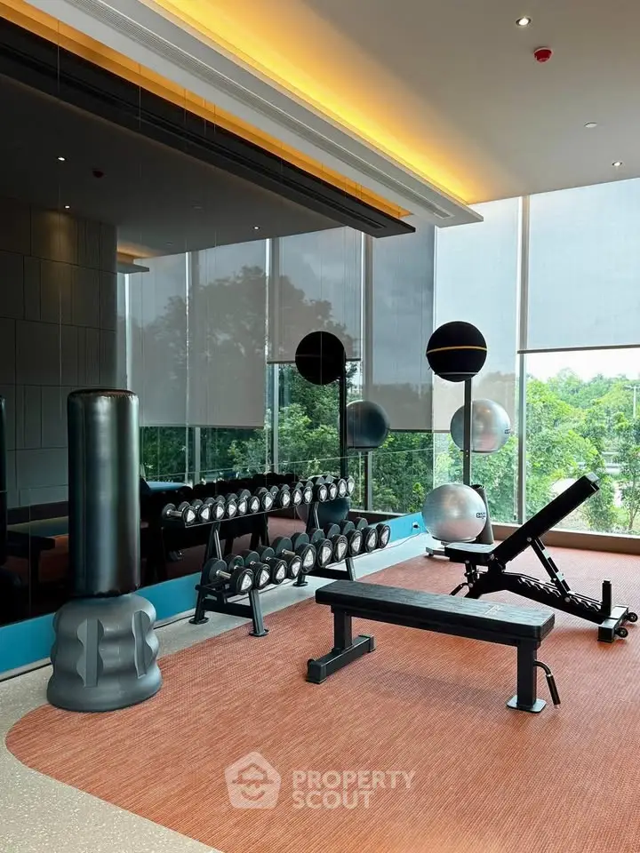 Modern gym with state-of-the-art equipment and scenic outdoor view, perfect for fitness enthusiasts.