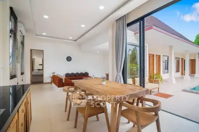 Spacious open-plan living area with wooden dining set and pool view, perfect for modern tropical living.
