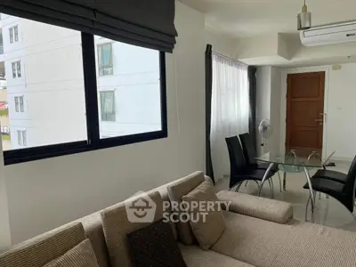 Modern living room with cozy sofa and dining area in bright apartment