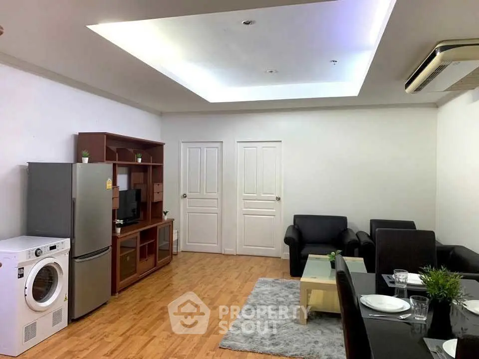 Modern living room with sleek furniture, washing machine, and open layout for comfortable living.