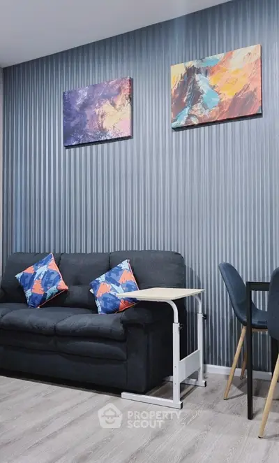 Modern living room with stylish decor and abstract art on walls