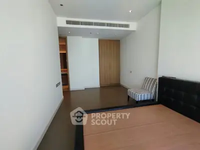 Spacious bedroom with modern design and elegant furnishings in a luxury apartment.