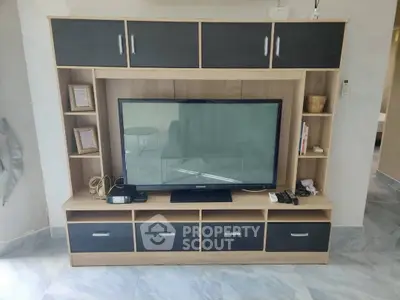 Modern living room with sleek TV unit and ample storage space