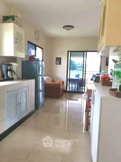 Charming kitchen with open layout and cozy seating area, featuring modern appliances and bright natural light.