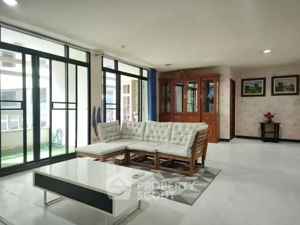 Spacious living room with modern furniture and large windows for natural light.