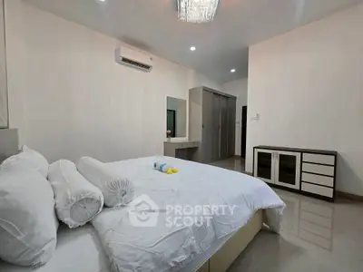 Spacious bedroom with modern furnishings and ample storage space.