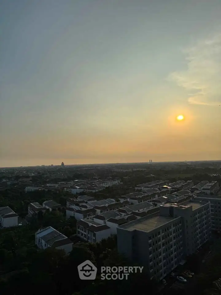 Stunning sunset view over a residential neighborhood with distant horizon.