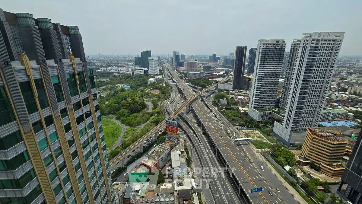 Stunning cityscape view from high-rise building showcasing urban skyline and major highways.