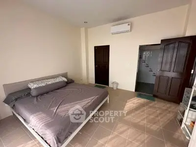 Spacious bedroom with modern decor and air conditioning, perfect for comfort and relaxation.