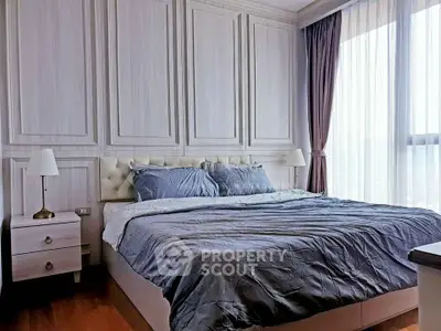 Luxurious bedroom with elegant paneling and large window for natural light.