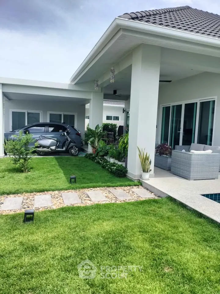 Modern home with lush garden and sleek exterior design, perfect for outdoor relaxation.