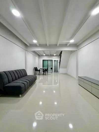 Spacious modern living room with sleek design and minimalist furniture, perfect for contemporary living.