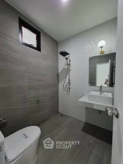 Modern minimalist bathroom with sleek fixtures and neutral tones.