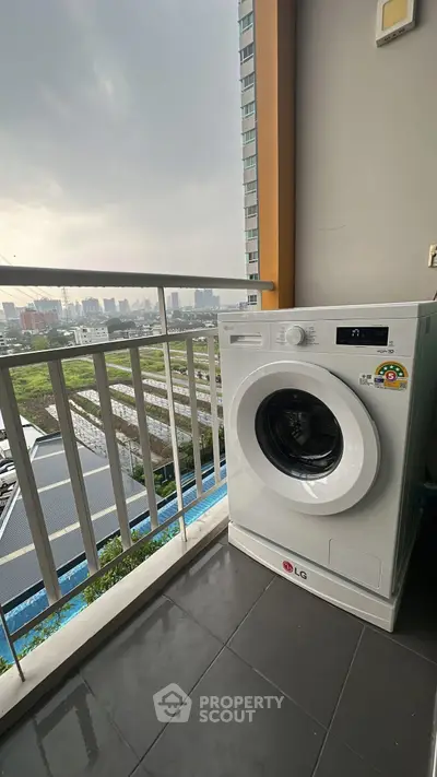 Modern balcony with washing machine and city view, perfect for urban living convenience.