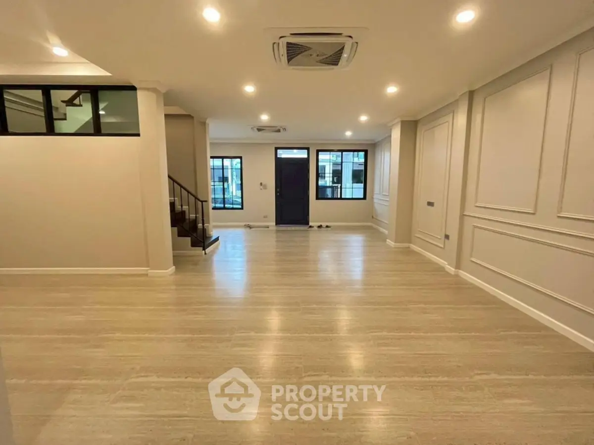 Spacious modern living room with elegant wood flooring and recessed lighting