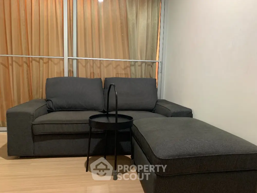 Cozy living room with modern dark sofa and stylish coffee table
