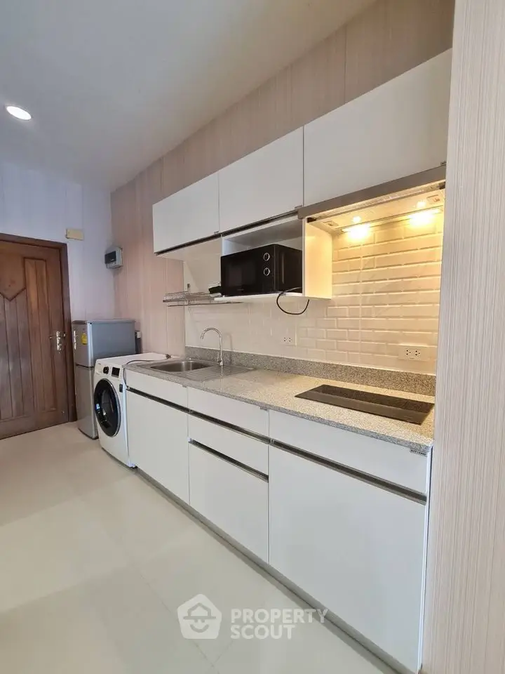 Modern kitchen with sleek cabinetry and built-in appliances in a stylish apartment.