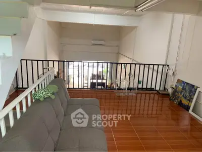 Spacious loft area with modern design and cozy seating, perfect for relaxation or creative work.