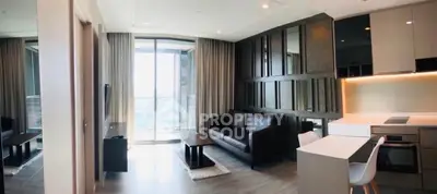 Modern living room with sleek design and large windows offering a stunning view.