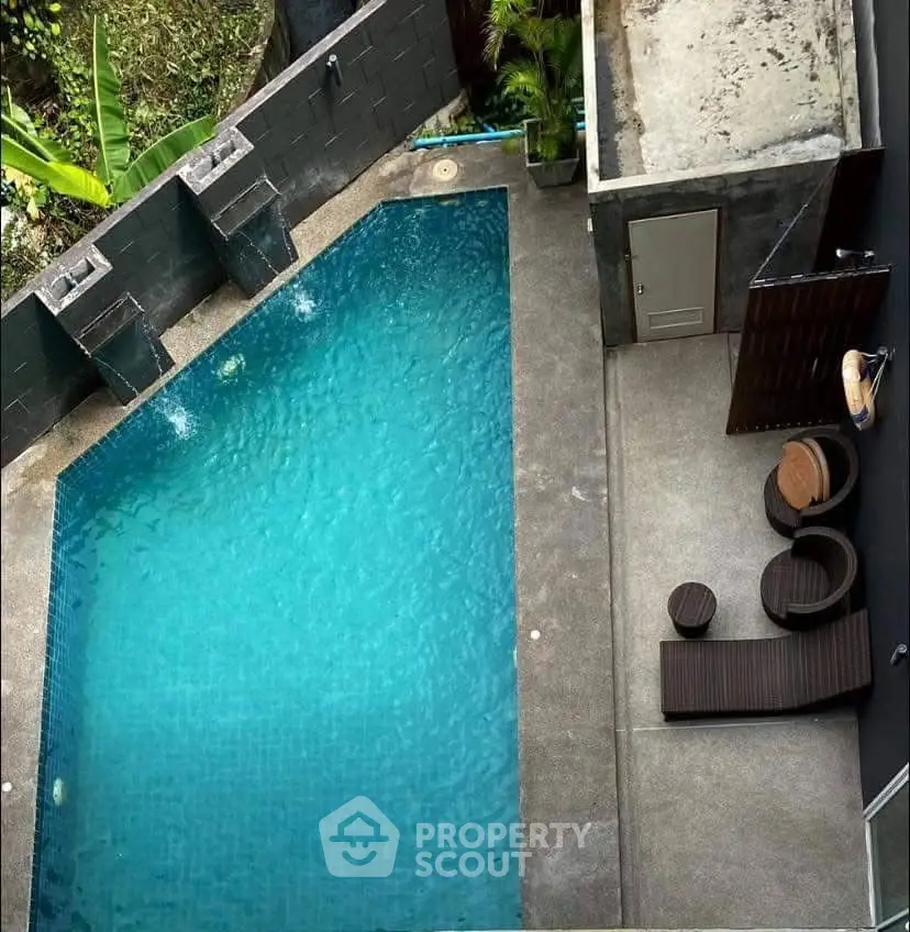 Luxurious private pool with modern design and cozy seating area, perfect for relaxation.