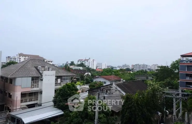 Scenic urban view with residential buildings and lush greenery, ideal for city living.