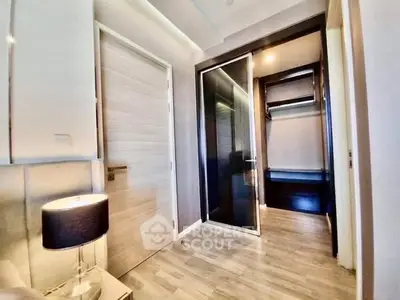 Modern bedroom with sleek closet and ambient lighting