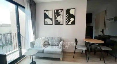 Modern living room with stylish decor and balcony access