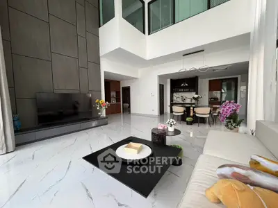 Luxurious modern living room with high ceilings and elegant decor in a contemporary apartment.