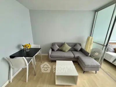 Modern living room with sleek furniture and natural light, perfect for urban living.