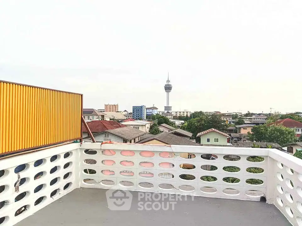 Stunning rooftop view with cityscape and iconic tower in the background.