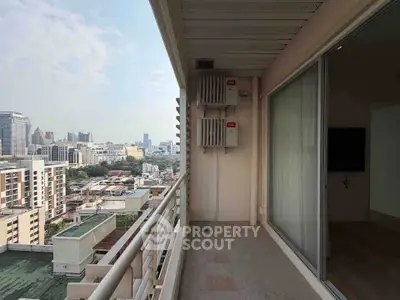 Spacious balcony with stunning city view in modern high-rise apartment