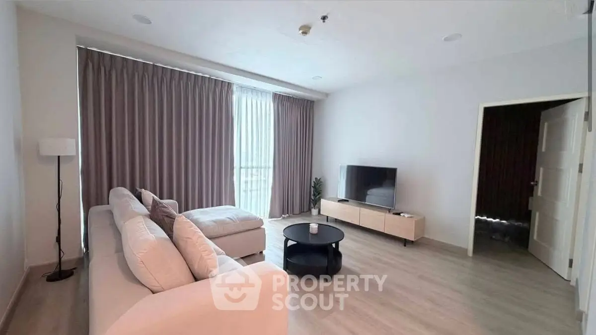 Spacious modern living room with large windows and elegant decor