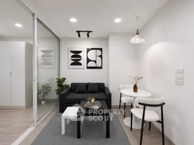 Modern living room with sleek furniture and stylish decor in a compact apartment setting.