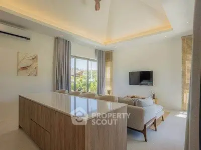 Luxurious living room with modern decor and large windows offering natural light.