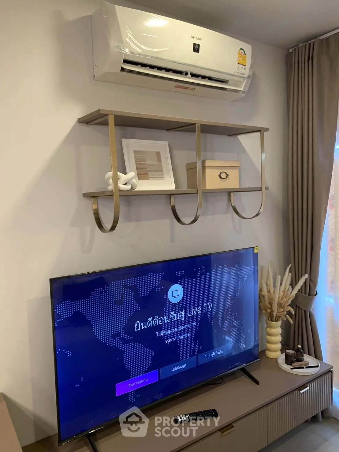 Modern living room with air conditioner and smart TV setup