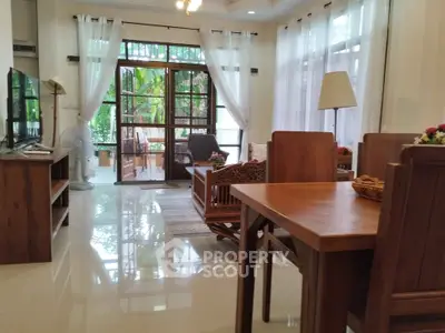 Spacious living room with elegant wooden furniture and garden view