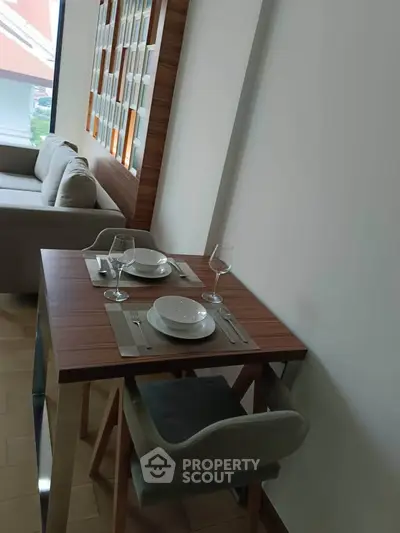 Modern dining area with stylish table and chairs in a cozy living space, perfect for urban living.