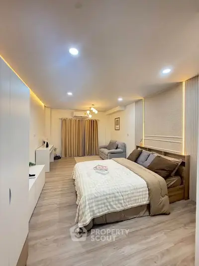 Spacious modern bedroom with cozy lighting and elegant decor