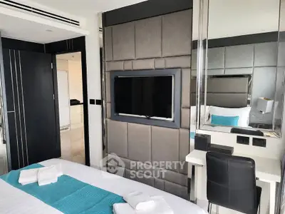 Modern bedroom with sleek design, featuring a wall-mounted TV and stylish decor, perfect for luxury living.