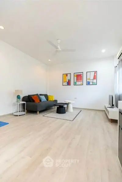 Spacious modern living room with stylish decor and ample natural light.