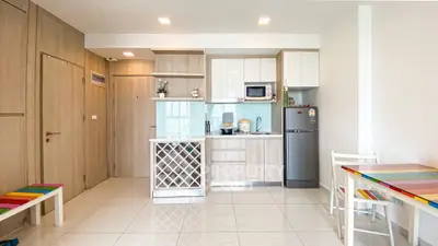 Modern kitchen with colorful dining set and sleek appliances