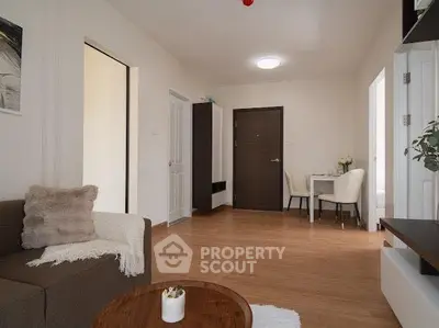 Cozy living room with modern decor and wooden flooring in a stylish apartment.