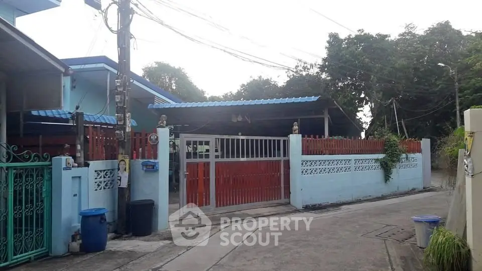 Charming suburban home with gated entrance and lush greenery, perfect for family living.