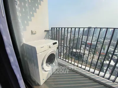 High-rise balcony with washing machine and stunning cityscape view.