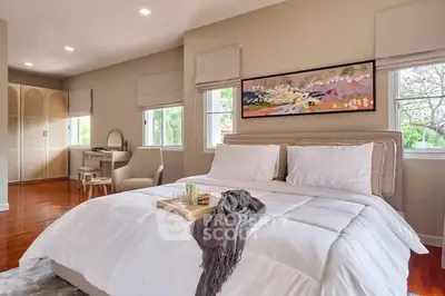 Luxurious bedroom with elegant decor and natural light, featuring a cozy bed and stylish furnishings.