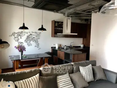 Modern open-plan living room with stylish kitchen and unique wall art