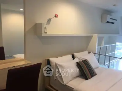 Modern bedroom with stylish decor and air conditioning in a cozy apartment.