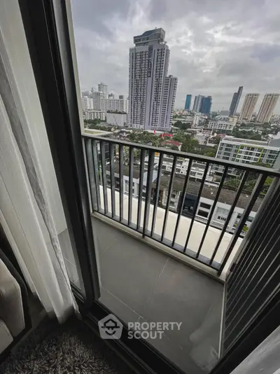 Stunning city view from a modern apartment balcony with sleek railing design.