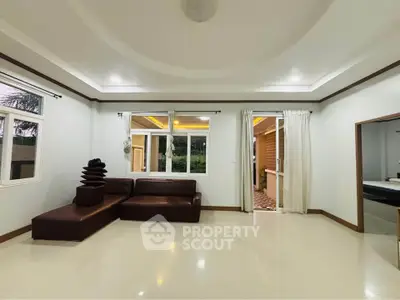 Spacious living room with modern design and large windows offering natural light.