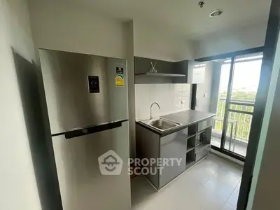 Modern kitchen with stainless steel fridge and balcony view